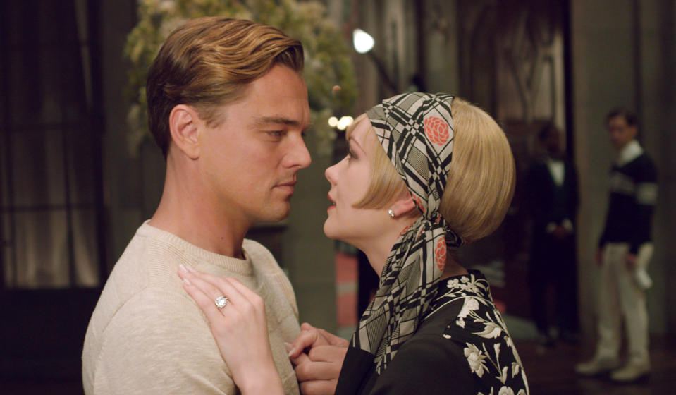 This film publicity image released by Warner Bros. Pictures shows Carey Mulligan as Daisy Buchanan, right, and Leonardo DiCaprio as Jay Gatsby in a scene from "The Great Gatsby." Baz Luhrmann's big screen adaption of “The Great Gatsby” is shining a spotlight on Roaring Twenties glam fashions, from drop-waist dresses and head scarves to crisp bow ties and spectator shoes. (AP Photo/Warner Bros. Pictures)