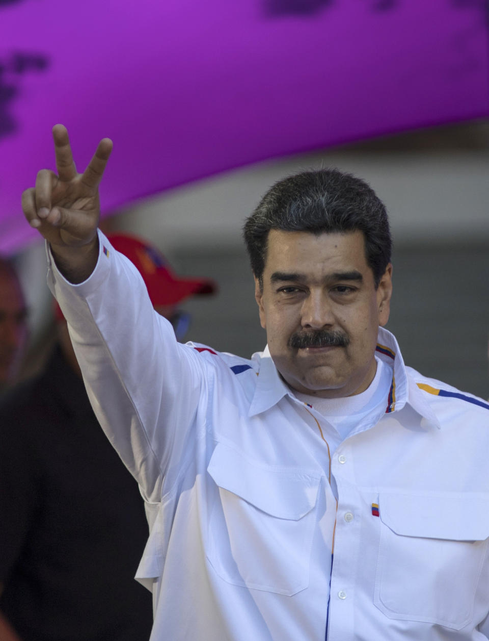 Venezuela's President Nicolas Maduro greets supporters during a pro-government demonstration in Caracas, Venezuela, Tuesday, Feb. 12, 2019. Venezuela's opposition is calling supporters into the streets across the country in a campaign to break the military's support of President Nicolas Maduro. The demonstrations come after more than a month of pressure led by opposition lawmaker Juan Guaido, while Maduro remains firmly in power and at the military's helm. (AP Photo/Rodrigo Abd)