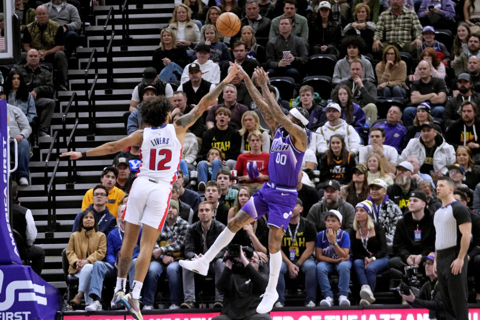 Utah Jazz guard Jordan Clarkson (00) shoots as Detroit Pistons forward Isaiah Livers (12) defends during the second half of an NBA basketball game Wednesday, Jan. 3, 2024, in Salt Lake City. (AP Photo/Rick Bowmer)