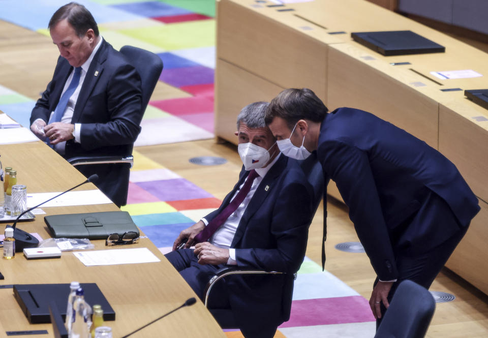 French President Emmanuel Macron, right, speaks with Czech Republic's Prime Minister Andrej Babis during a round table meeting at an EU summit at the European Council building in Brussels, Thursday, Oct. 15, 2020. European Union leaders are meeting in person for a two-day summit amid the worsening coronavirus pandemic to discuss topics ranging from Brexit to climate and relations with Africa. (Kenzo Tribouillard, Pool via AP)