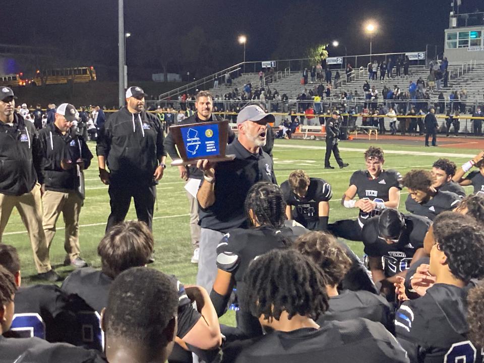 Coach Matt Demarest holds the North 1, Group 5 championship trophy as he addresses his Passaic Tech football team following a 14-7 win over Union City in the sectional final on Nov. 12, 2022.