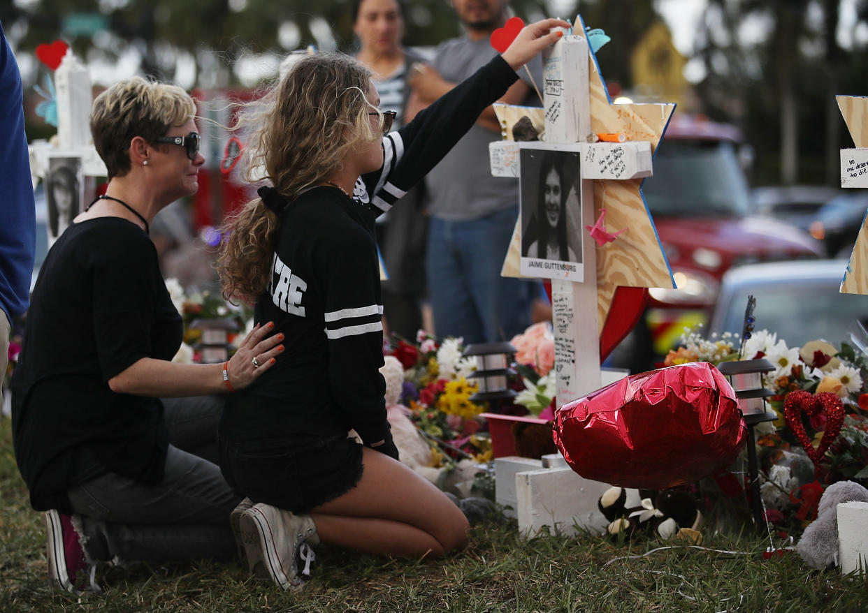 Friends mourned Jaime Guttenberg at a makeshift memorial last February, days after she and 16 others were killed. (Photo: Joe Raedle/Getty Images)