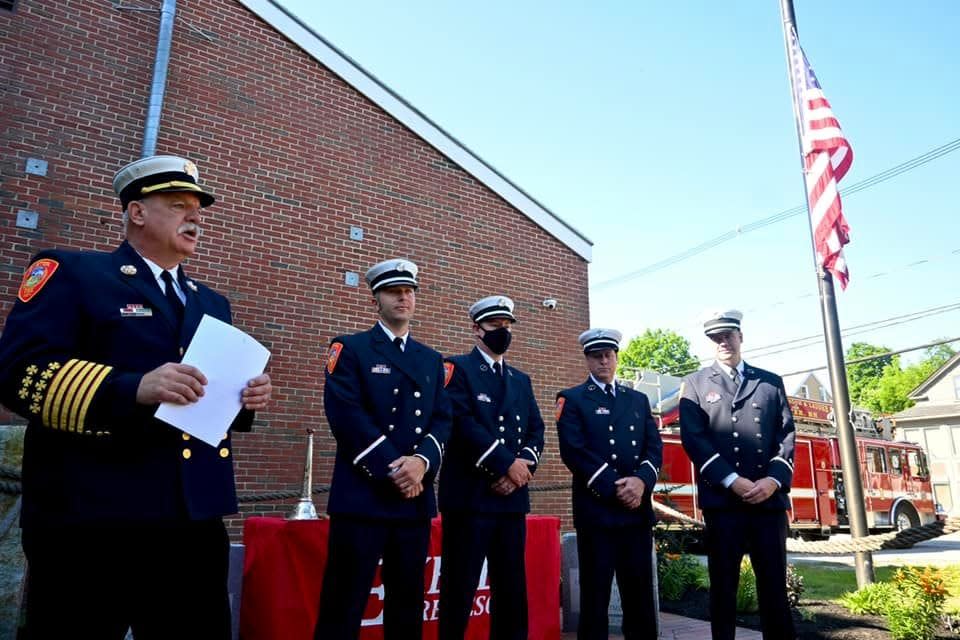 Fire Chief Eric Wilking leads a promotional ceremony for new lieutenants and captains on July 7. From left, Lt. Stephen Holmes, Lt. Ryan Booth, Lt. Timothy Sirois and Lt. Matthew Slattery.