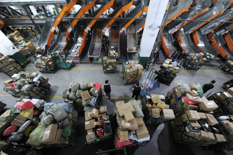 Employees sort parcels and boxes at a logistic centre of a postal service a day ahead of the Singles' Day online shopping festival in Nanjing