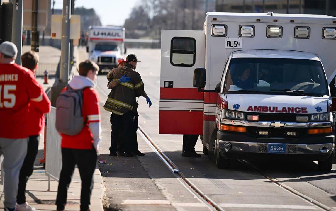 A firefighter waits outside an ambulance near Union Station after several people were shot near a parade there during the Kansas City Chiefs' Super Bowl victory parade on Feb. 14, 2024, in Kansas City, Mo.