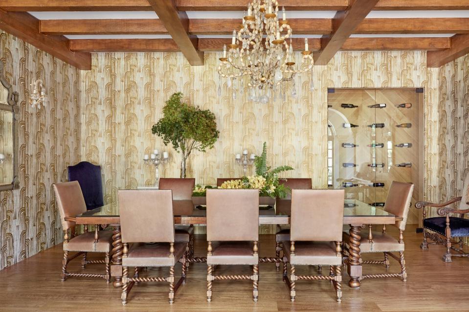 The dining room receives a pop of whimsy from the Kelly Wearstler wallpaper. The dining room table is from Dos Gallos with chairs from Ebanista. The chandelier is another custom piece from Farahan.