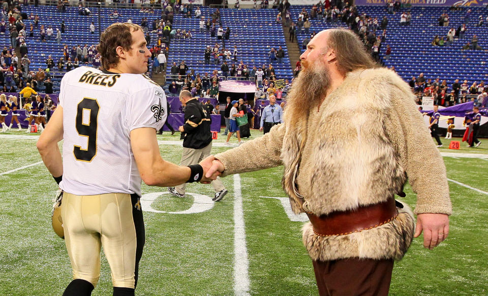 <p>(L-R) Drew Brees #9 of the New Orleans Saints shakes hands with Minnesota Vikings mascot Ragnar after the Saints defeated the Vikings 42-20 at the Hubert H. Humphrey Metrodome on December 18, 2011 in Minneapolis, Minnesota. (Photo by Adam Bettcher /Getty Images) </p>