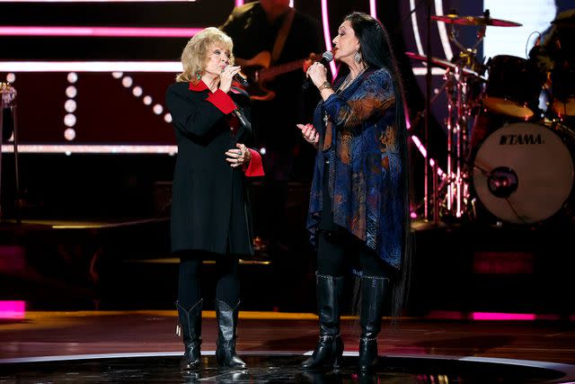 <p>Jason Kempin/Getty </p> October 14, 2022 Peggy Sue Wright (L) and Crystal Gayle perform onstage during the 2022 CMT Artists of the Year at Schermerhorn Symphony Center on October 12, 2022 in Nashville, Tennessee.