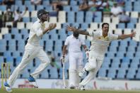 Australia's Mitchell Johnson (R) celebrates after the dismissal of South Africa's Faf du Plessis who was caught out by his captain Michael Clarke during the second day of their cricket test match in Centurion February 13, 2014. REUTERS/Siphiwe Sibeko (SOUTH AFRICA - Tags: SPORT CRICKET)