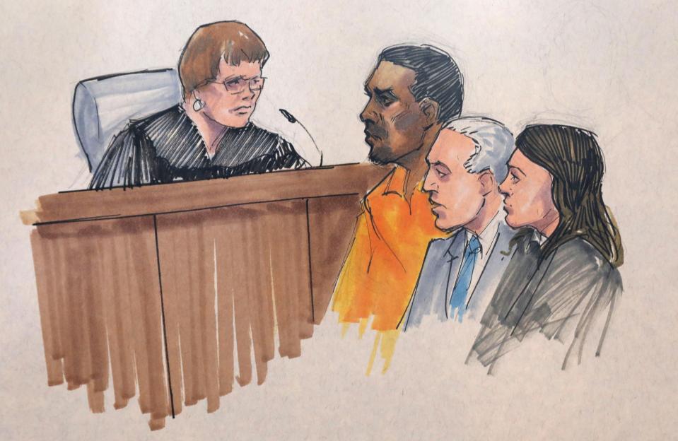In this courtroom sketch, R. Kelly, center, appears before U.S. Magistrate Shelia M. Finnegan in the Northern District of Illinois, on July 12, 2019, in Chicago. Also standing with Kelly is his attorney Steve Greenberg and an unidentified prosecutor.