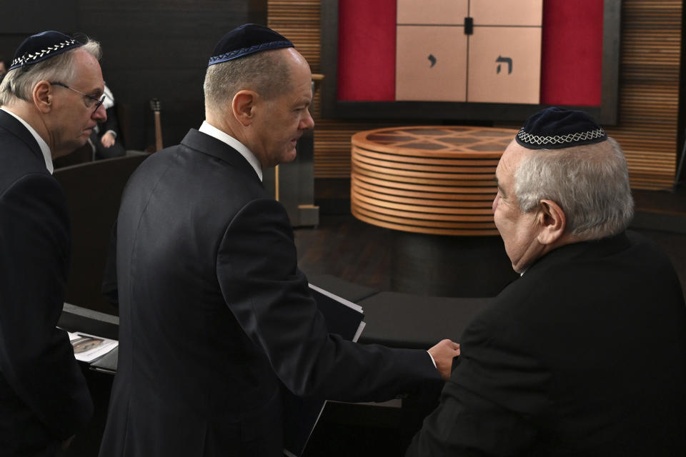 From right, Alexander Wassermann , chairman of the Jewish community in Dessau, shakes hands with German Chancellor Olaf Scholz, stood next to Reiner Haseloff, Minister President of Saxony-Anhalt. during the inauguration of the newly built synagogue in Dessau, Germany, Sunday, Oct. 22, 2023. Scholz said Germany will do everything to protect and strengthen Jewish life in his remarks at the inauguration of the Weill Synagogue in Dessau. (Hendrik Schmidt/Pool Photo via AP)