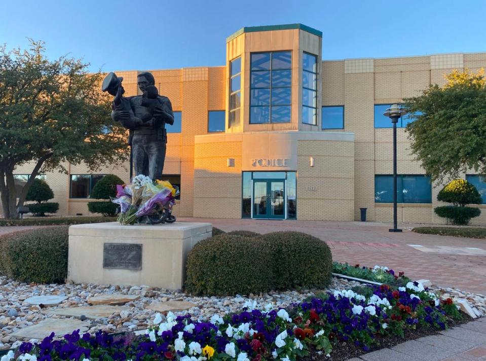 Euless police placed flowers on a memorial in front of their headquarters in memory of Detective Alejandro Cervantes, who was killed Saturday in a crash involving an accused drunken driver.