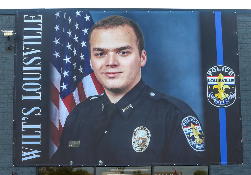 A banner of LMPD officer Nickolas Wilt hangs on the building at 9824 Bluegrass Parkway on Monday, April 24, 2023