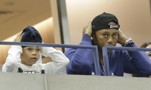 ADDS THE NAME OF TIGER WOODS SON, CHARLIE - Golfer Tiger Woods watches a match between Rafael Nadal, of Spain, and Marin Cilic, of Croatia, with his son, Charlie, during the fourth round of the U.S. Open tennis tournament, Monday, Sept. 2, 2019, in New York. (AP Photo/Seth Wenig)