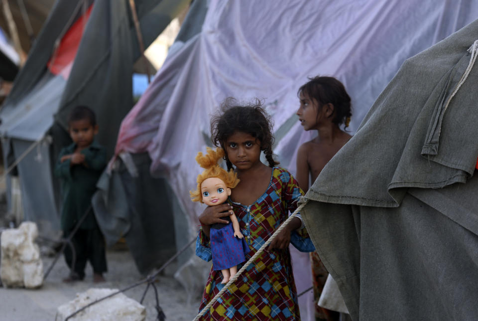 An affected girl poses for photograph as she takes refuge after her home was hit by floods in Shikarpur district of Sindh Province, of Pakistan, Thursday, Sep. 1, 2022. Pakistani health officials on Thursday reported an outbreak of waterborne diseases in areas hit by recent record-breaking flooding, as authorities stepped up efforts to ensure the provision of clean drinking water to hundreds of thousands of people who lost their homes in the disaster. (AP Photo/Fareed Khan)