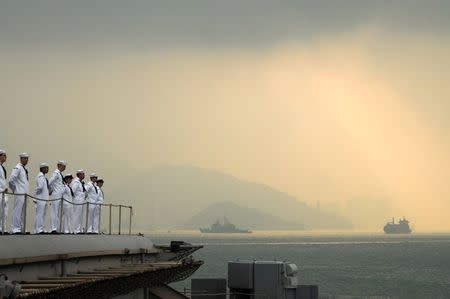 Sailors aboard the aircraft carrier USS George Washington man the rails as the ship pulls out of Hong Kong after a five-day port visit in this U.S. Navy handout photo dated November 14, 2011. REUTERS/U.S. Navy/Mass Communication Specialist Seaman Erin Devenberg/Handout/File Photo