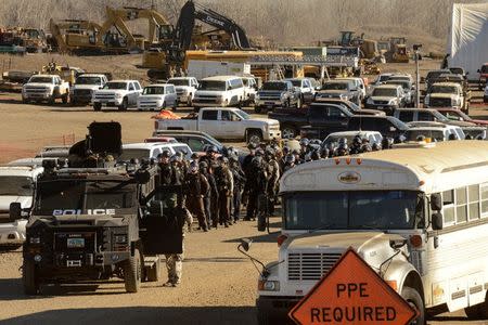 Police stand guard in a Dakota Access pipeline construction facility during a protest against the Dakota Access pipeline near the Standing Rock Indian Reservation in Mandan, North Dakota, U.S. November 12, 2016. REUTERS/Stephanie Keith