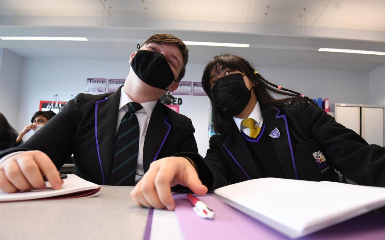 Children wearing facemasks during a lesson at Hounslow Kingsley Academy in West London, as pupils in England return to school for the first time in two months as part of the first stage of lockdown easing. Picture date: Monday March 8, 2021. PA Photo.  - Kirsty O'Connor/PA Wire