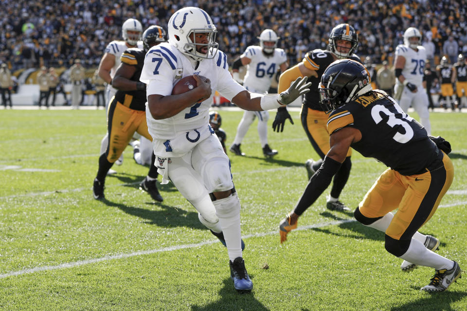 Indianapolis Colts quarterback Jacoby Brissett (7) scrambles away from Pittsburgh Steelers strong safety Terrell Edmunds (34) in the first half of an NFL football game , Sunday, Nov. 3, 2019, in Pittsburgh. (AP Photo/Don Wright)