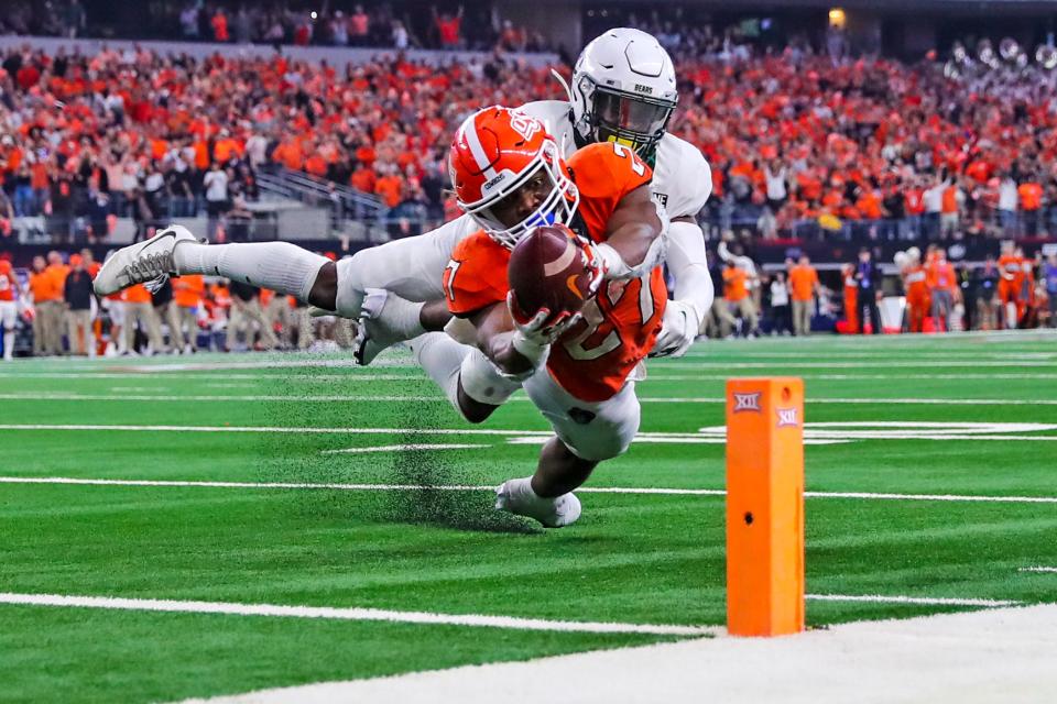 Baylor's Jairon McVea stops Oklahoma State running back Dezmon Jackson.