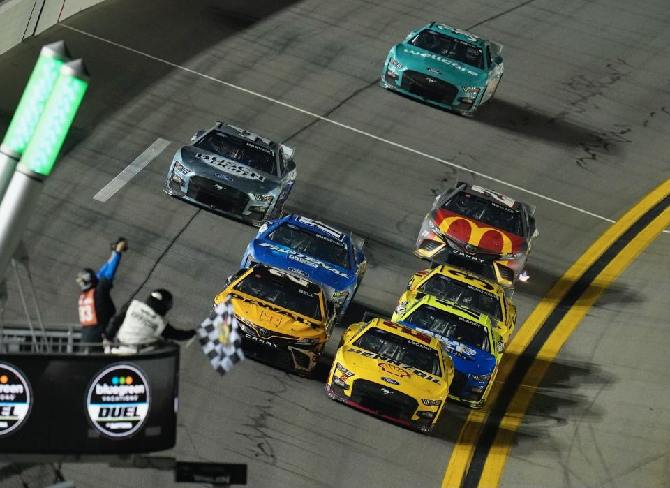 Joey Logano (22) holds off Christopher Bell (20) to win the first Bluegreen Vacations Duel race on Thursday night at Daytona International Speedway.