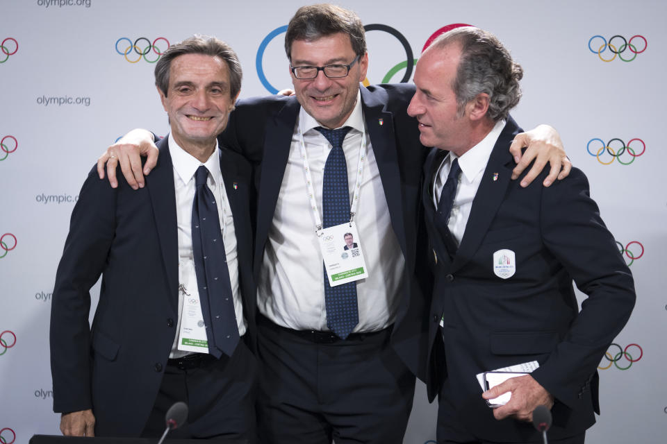 From left, Italy's Lombardy region President Attilio Fontana, Italy's Under Secretary of State Giancarlo Giorgetti and Italy's Veneto Region President Luca Zaia pose after Milan-Cortina won the bid to host the 2026 Winter Olympic Games, during the first day of the 134th Session of the International Olympic Committee (IOC), at the SwissTech Convention Centre, in Lausanne, Switzerland, Monday, June 24, 2019. Italy will host the 2026 Olympics in Milan and Cortina d'Ampezzo, taking the Winter Games to the Alpine country for the second time in 20 years. (Laurent Gillieron/Keystone via AP)