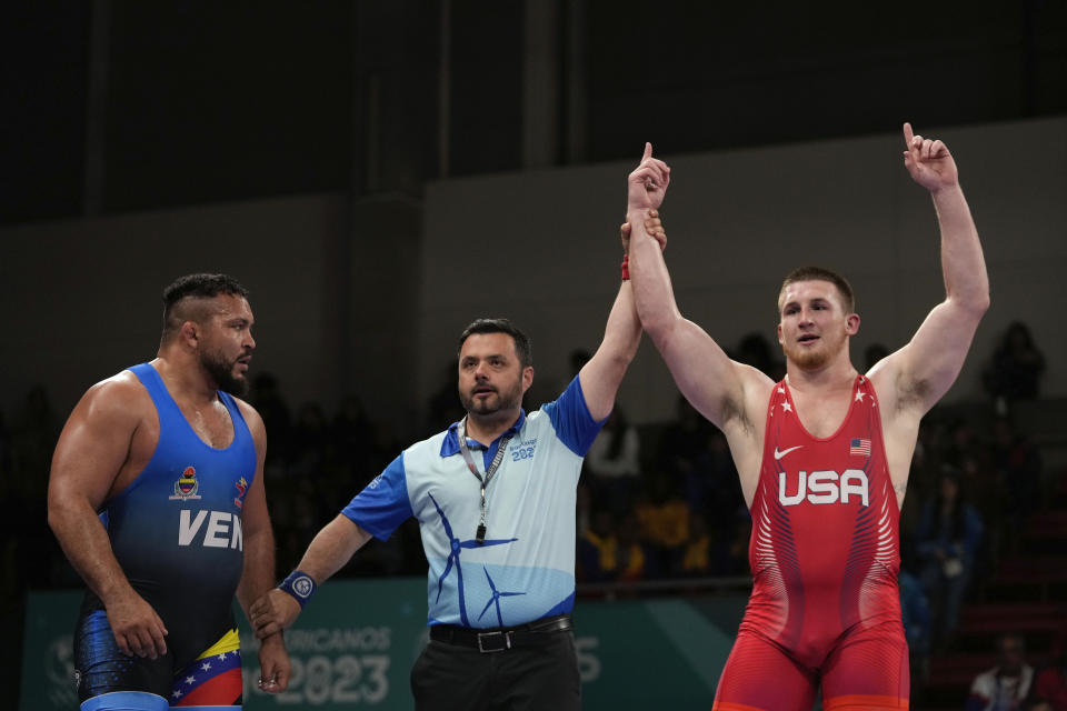 Mason Parris of the United States, right, celebrates after winning against Venezuela's Jose Diaz, right, during the men's 125kg wrestling freestyle final bout at the Pan American Games Santiago, Chile, Wednesday, Nov. 1, 2023. (AP Photo/Matias Delacroix)