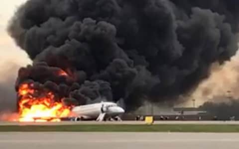 Passengers escape from the burning plane on evacuation slides - Credit: Russian investigative committee/TASS/Barcroft