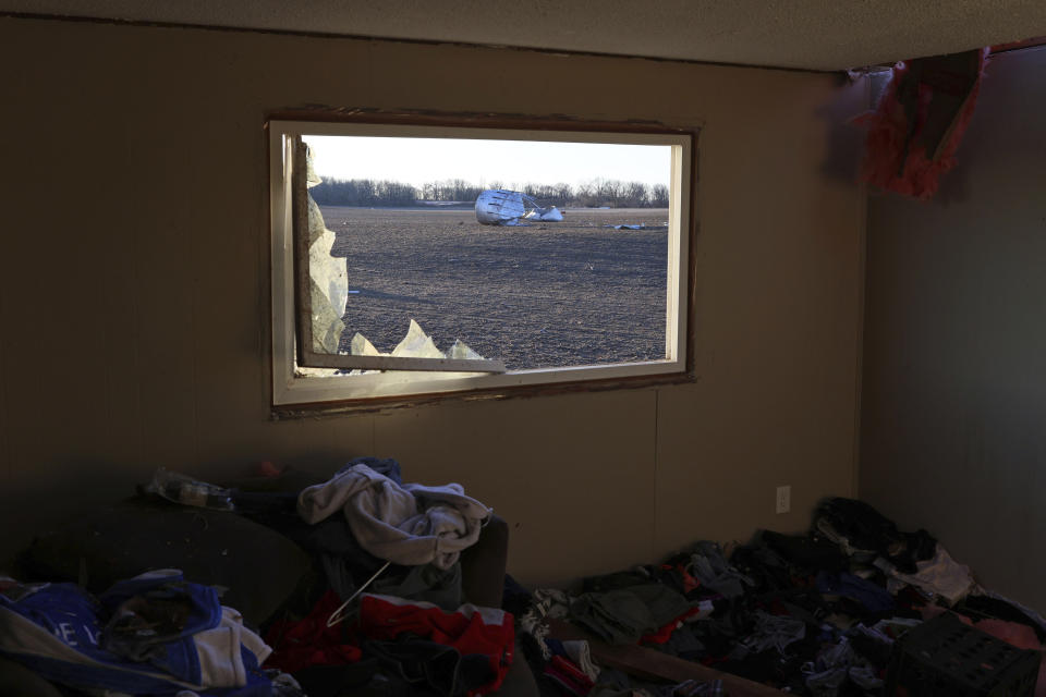 Debris can be seen outside the home of Patrick Crull, Friday morning, Feb. 9, 2024, after a confirmed tornado went through the area along North Tolles Road, just northwest of Evansville, Wis., the prior evening. Crull and his girlfriend moved into the house last December after several months of remodeling the interior. The tornado was the first-ever reported in February in the state of Wisconsin, according to the National Weather Service. (Anthony Wahl//The Janesville Gazette via AP)