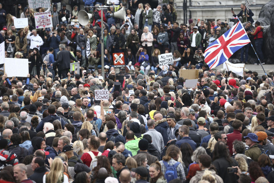 Protesters gather opposed to COVID-19 pandemic restrictions, in Trafalgar Square, London, Saturday, Aug. 29, 2020. This protest shows solidarity with a protest held in Germany where tens of thousands of people gathered at the German capital's iconic Brandenburg Gate in the morning before streaming down the Unter den Linden boulevard in a show of defiance against Germany's coronavirus prevention measures. (Yui Mok/PA via AP)