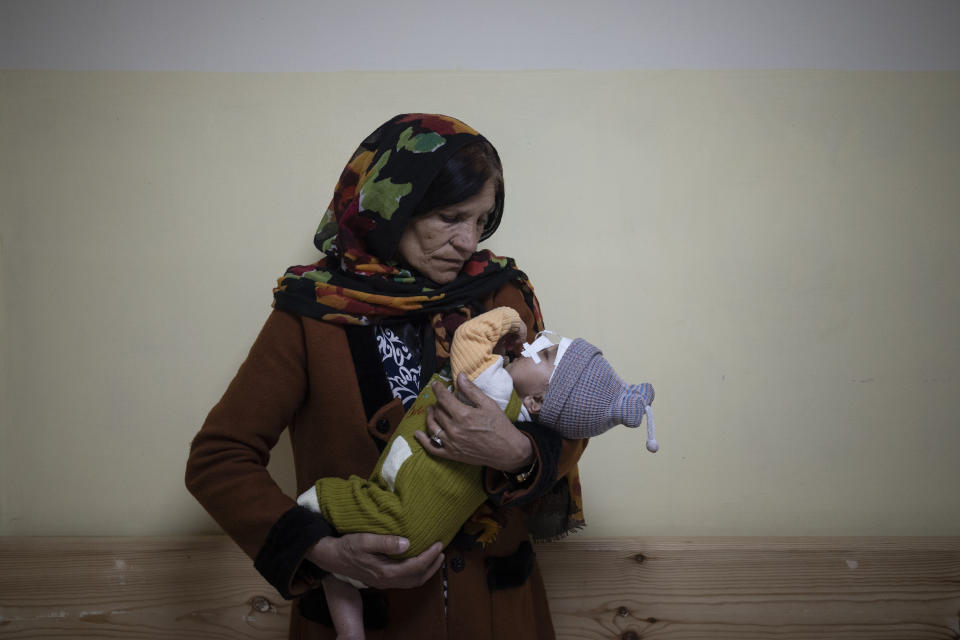 Simien Arian holds her malnourished nine-month-old grandchild Maaz in the Indira Gandhi hospital in Kabul, Afghanistan, Monday, Nov. 8, 2021. The number of people living in Afghanistan in near-famine conditions has risen to 8.7 million according to the World Food Program. (AP Photo/Bram Janssen)