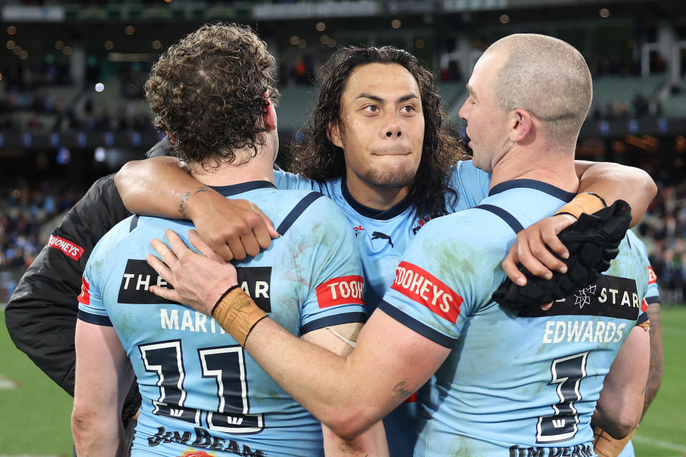 MELBOURNE, AUSTRALIA - JUNE 26:  Jarome Luai of the Blues celebrates with Liam Martin of the Blues and Dylan Edwards of the Blues after winning game two of the men's State of Origin series between New South Wales Blues and Queensland Maroons at the Melbourne Cricket Ground on June 26, 2024 in Melbourne, Australia. (Photo by Cameron Spencer/Getty Images)