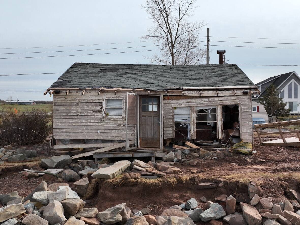 A damaged house, pictured, following the landfall of post-tropical storm Fiona in Nova Scotia in September 2022. Officials from the Department of Environment and Climate Change predict more weather disasters unless greenhouse gas emissions fall dramatically in coming years.  (Patrick Morrell/CBC - image credit)