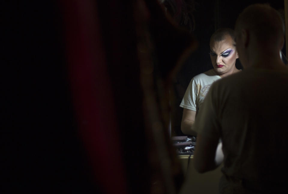 In this photo taken Saturday, Feb. 8, 2014, Zaza Napoli, who would only give his stage name, gets ready before a show backstage at the Mayak cabaret, the most reputable gay club in Sochi, Russia, host to 2014 Winter Olympics. Russia adopted a law last year, prohibiting vaguely defined propaganda of non-traditional sexual relations and pedophilia. The legislation makes it illegal to disseminate information to children even if it merely shows that gay people are just like everybody else. At Mayak, packed on Saturday night, gay men and women steered away from discussing the law, preferring to enjoy life, closeted as it is. About a hundred people were chatting at the bar, sitting in armchairs or dancing. Couples were sharing kisses. Everyone was waiting for the club's specialty: a drag show. At 1.30 a.m. on Sunday, the music stopped and the show began. (AP Photo/David Goldman)