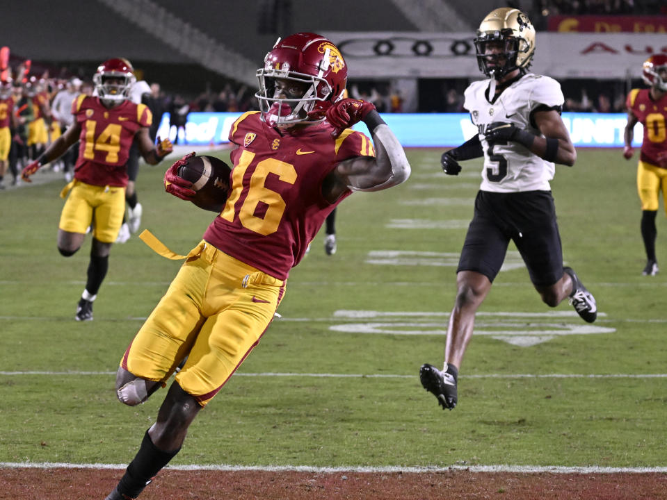 Southern California wide receiver Tahj Washington celebrates his touchdown, as Colorado safety Tyrin Taylor trails during the second half of an NCAA college football game Friday, Nov. 11, 2022, in Los Angeles. (AP Photo/John McCoy)