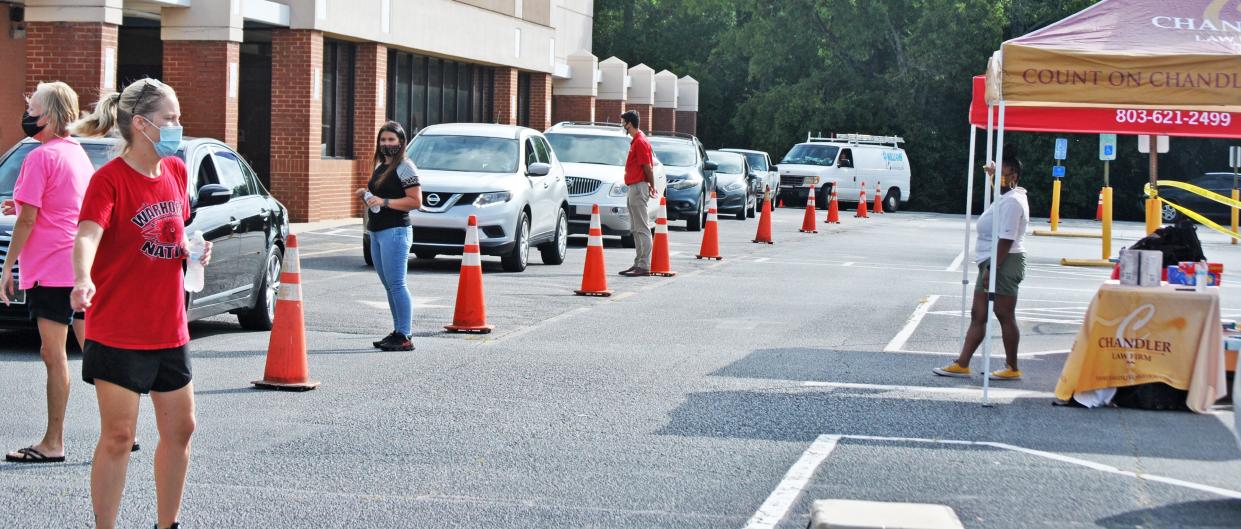 Due to COVID-19, this year's back-to-school bash was held drive-thru style with a long line of cars lining the Cricket Wireless parking lot in Barnwell.