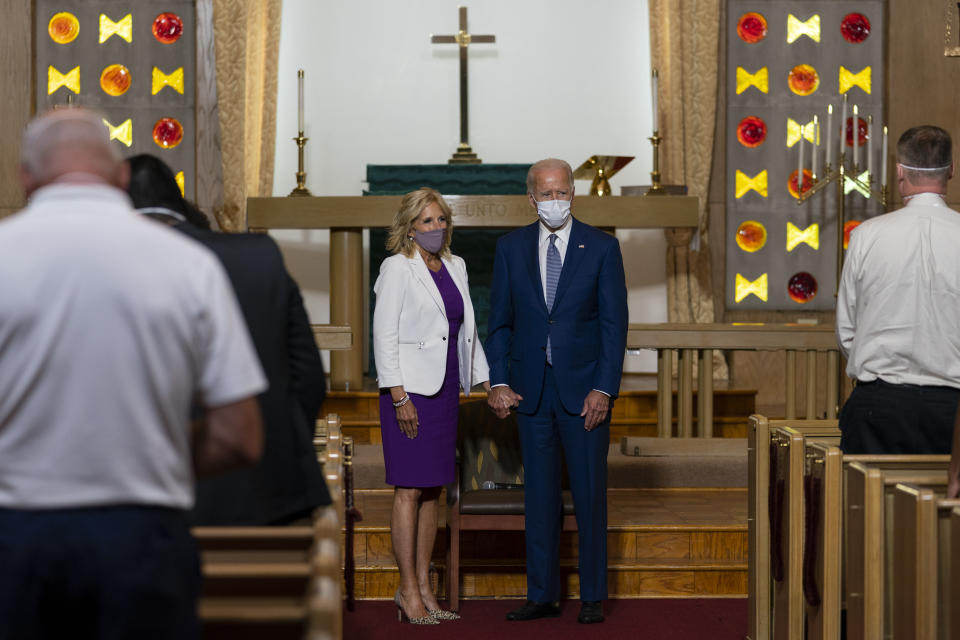 FILE- In this Sept. 3, 2020, file photo Democratic presidential candidate former Vice President Joe Biden holds hands with his wife Jill Biden during a community meeting at Grace Lutheran Church in Kenosha, Wis. (AP Photo/Carolyn Kaster, File)