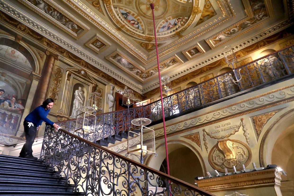 A Historic Royal Palaces Conservator cleans the King's Staircase ahead of the re-opening of Kensington Palace to the public tomorrow on July 29, 2020, in London, England. Kensington Palace has been closed to visitors for four months due to COVID-19.