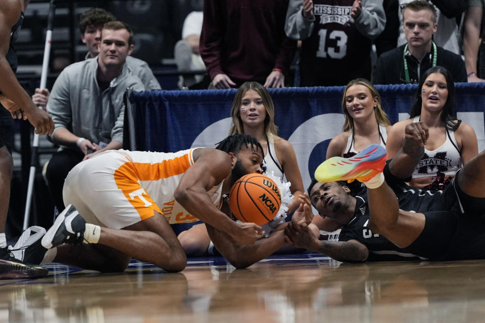 Tennessee guard Josiah-Jordan James (30) and Mississippi State forward D.J. Jeffries (0) scramble for a loose ball during the first half of an NCAA college basketball game at the Southeastern Conference tournament Friday, March 15, 2024, in Nashville, Tenn. (AP Photo/John Bazemore)