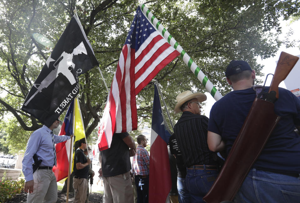 Gun rights advocates gather outside the Texas Capitol where Texas Gov. Greg Abbott held a round table discussion, Thursday, Aug. 22, 2019, in Austin, Texas. Abbott is meeting in Austin with officials from Google, Twitter and Facebook as well as officials from the FBI and state lawmakers to discuss ways of combatting extremism in light of the recent mass shooting in El Paso that reportedly targeted Mexicans. (AP Photo/Eric Gay)