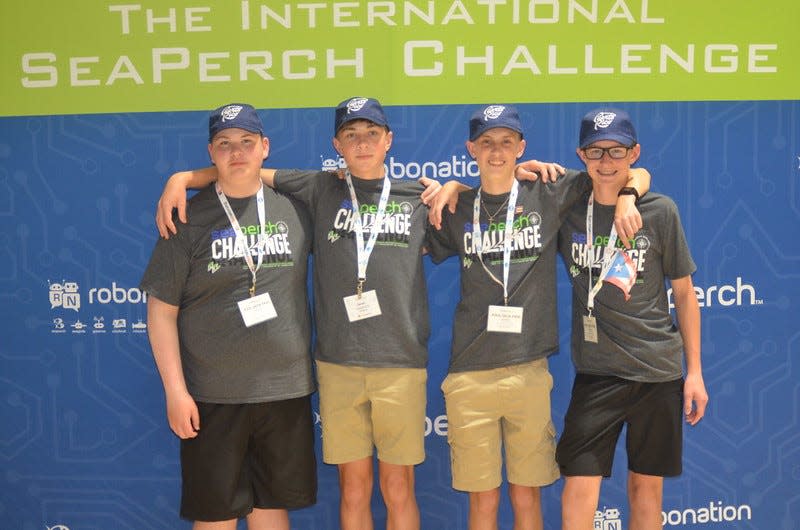 The Clinton High School OceanPerch Team, from left, of Brian Ferree, Jaren Settles, Gabe Manchester and Robert McDonald was chosen to give a presentation of their experience in the engineering process and design of their underwater robots during the 2023 International SeaPerch Challenge on May 13 at the University of Maryland.