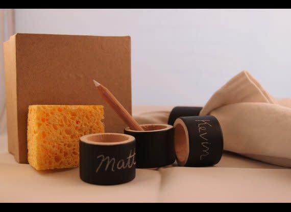 We adore these two-in-one napkin rings and place cards made by etsy Artisan <a href="http://www.etsy.com/listing/82896875/chalkboard-napkin-rings-reusable?ref=sr_gallery_10&ga_search_submit=&ga_search_query=napkin+ring&ga_view_type=gallery&ga_ship_to=US&ga_page=4&ga_search_type=handmade&ga_facet=handmade" target="_hplink">re*architect</a>. If you have blank napkin rings, just apply chalkboard paint, wait for it to dry and you're done.     Photo by re*architect