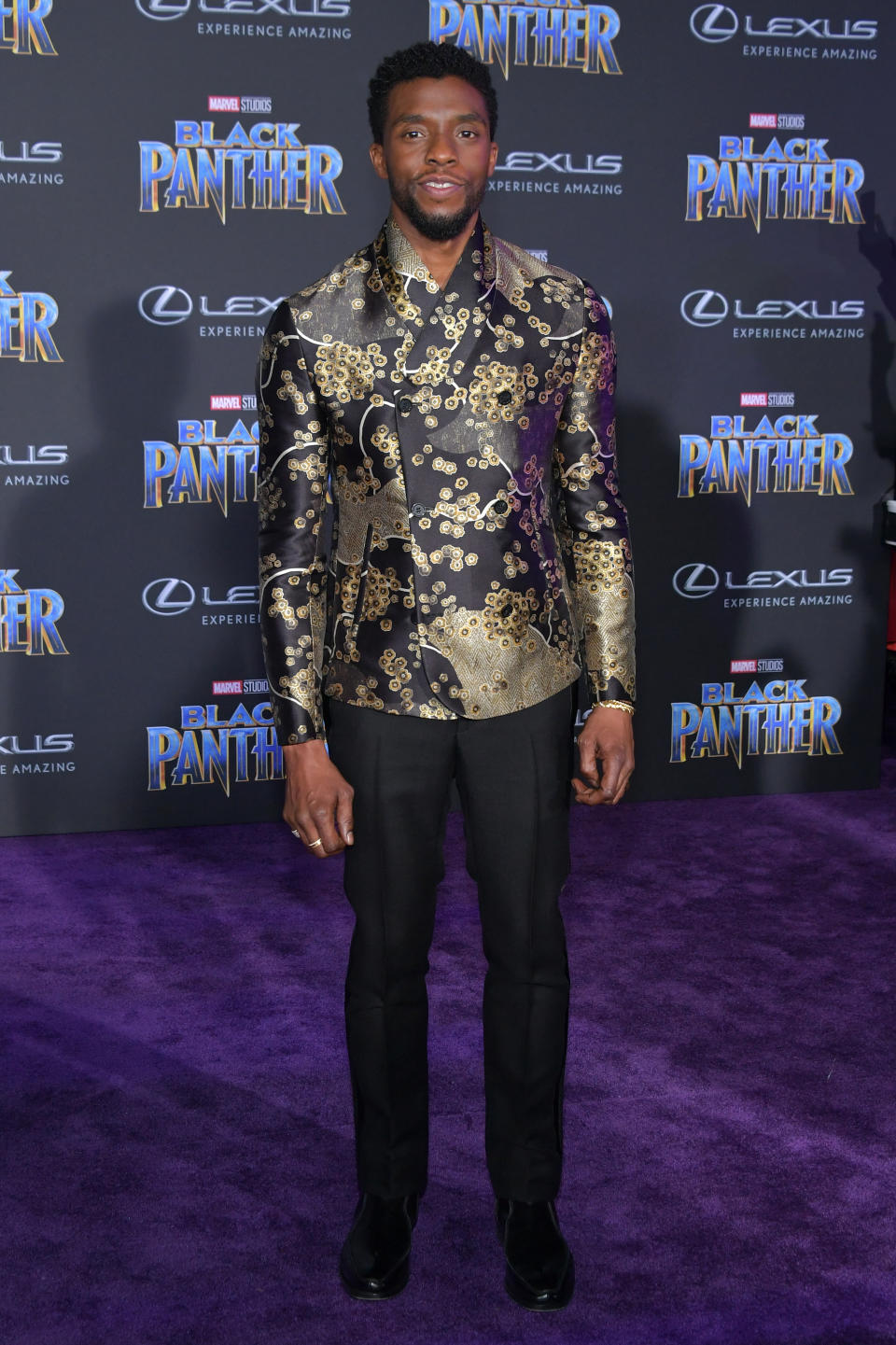 <p>The film’s star, who plays T’Challa, wore a patterened black gold and purple silk dress shirt. <em>[Photo: Getty]</em> </p>