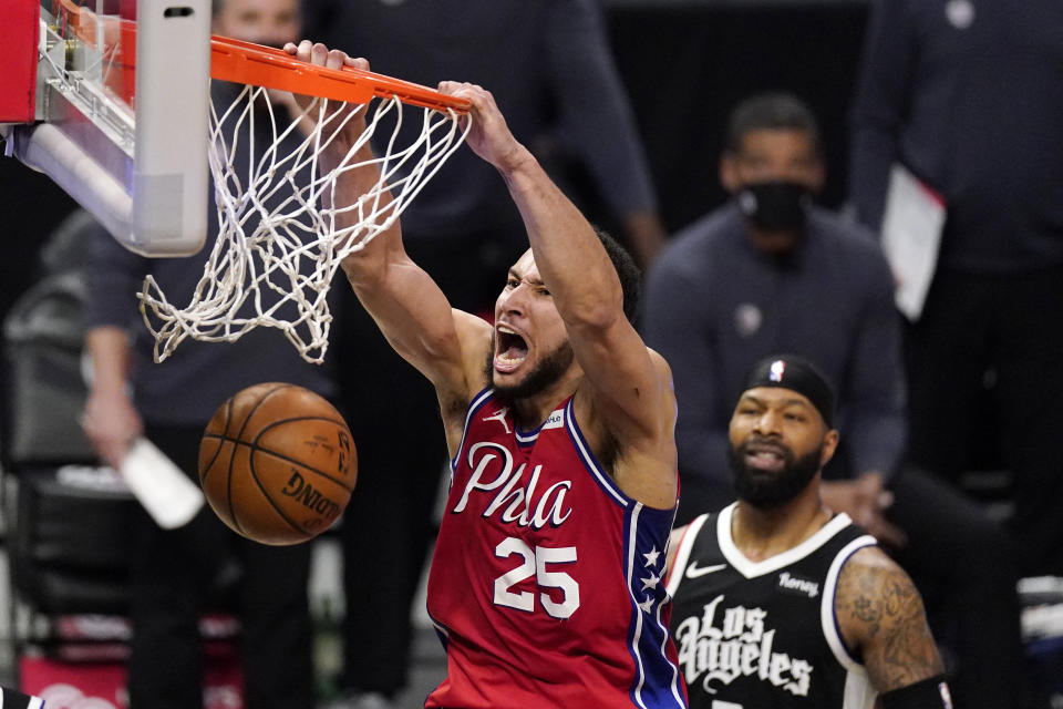 Philadelphia 76ers guard Ben Simmons, left, dunks as Los Angeles Clippers forward Marcus Morris Sr. watches during the second half of an NBA basketball game Saturday, March 27, 2021, in Los Angeles. The Clippers won 122-112. (AP Photo/Mark J. Terrill)