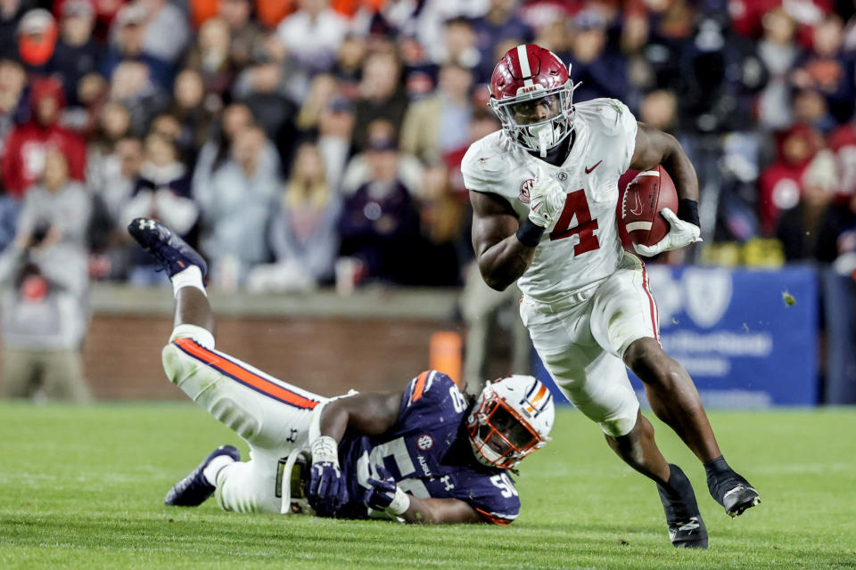 FILE - Alabama running back Brian Robinson Jr. (4) carries the ball against Auburn during the second half of an NCAA college football game Nov. 27, 2021, in Auburn, Ala. Alabama plays Georgia in the College Football Playoff national championship game on Jan. 10, 2022. (AP Photo/Butch Dill, File)