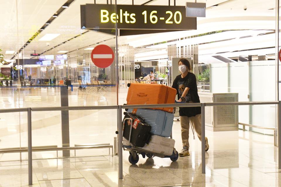 A Chinese traveller comes out of the arrival hall after landing at Singapore Changi Airport in Singapore.