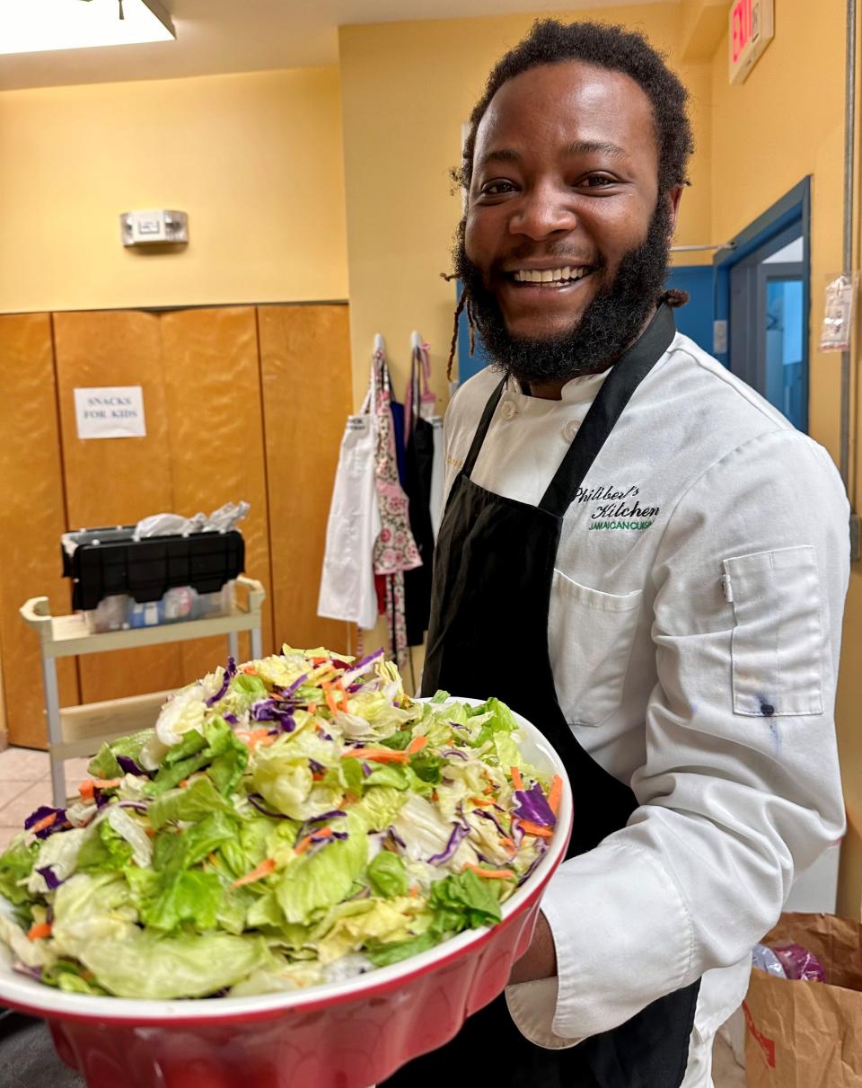 Chef Kamal Philibert shows a salad created during one of his cooking classes for children in the kitchen of the Dorcas Outreach Center for Kids – The DOCK -- in Melbourne’s Booker T. Washington neighborhood.