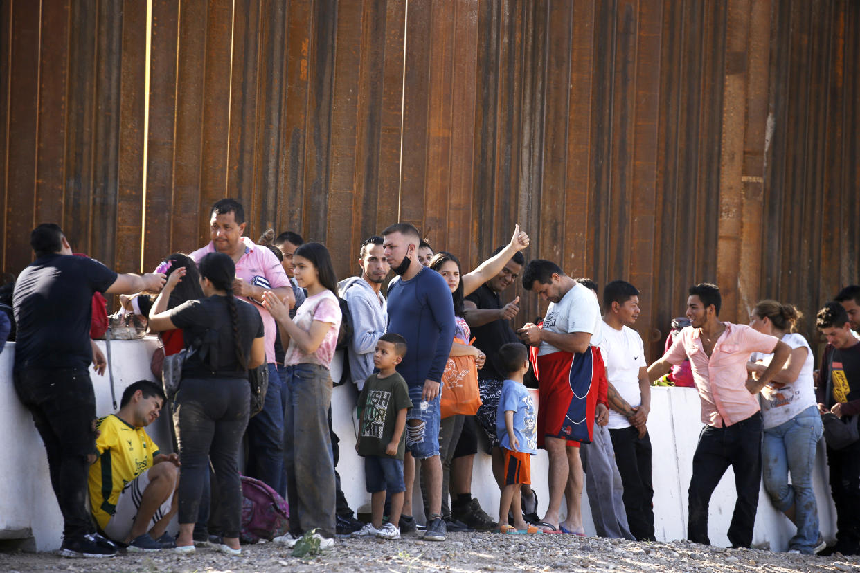 Migrants wait for US Border Patrol to be taken to a detention center on May 26 2022 in Eagle Pass Texas, USA. Title 42, the Trump era mandate which was set to prevent migrants from entering the US, was to expire on May 23 but was blocked by a lawsuit filed by several states citing that the move to strike down the law 