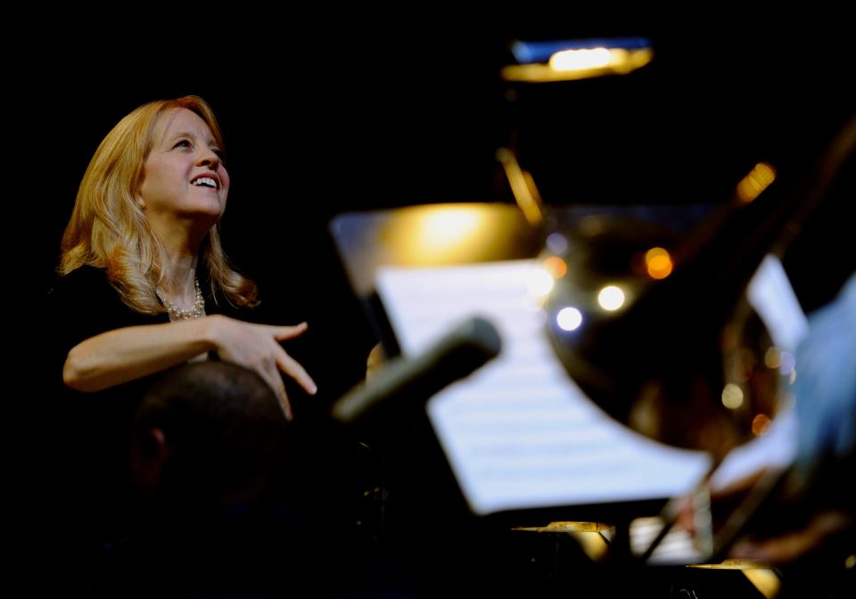 Maria Schneider conducts her jazz orchestra.