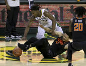 Oklahoma State guard Cade Cunningham (2) injures his ankle as he and Baylor guard Davion Mitchell (45) reach for the loose ball in the second half of an NCAA college basketball game, Thursday, March 4, 2021, in Waco, Texas. (AP Photo/Jerry Larson)